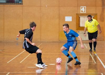 University of Auckland student playing Futsal against AUT