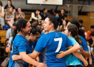 The University of Auckland Women's Volleyball team having a team huddle