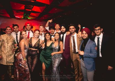 A group of students posing for a photo at the hall ball
