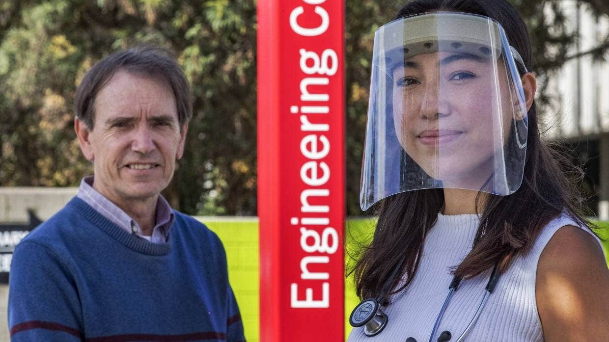 Student and her dad wearing her own designed face shield