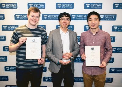 Three young men, two with co-curricular certificates